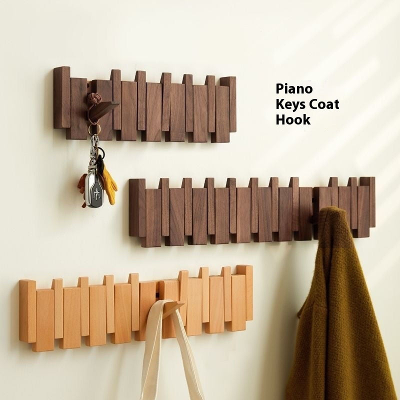 Piano key wall mounted wood coat rack with 8 flip down hooks in entryway