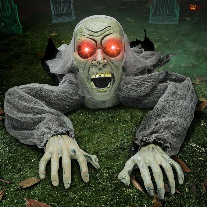 Zombie groundbreaker Halloween decoration with glowing red eyes on lawn with tombstones